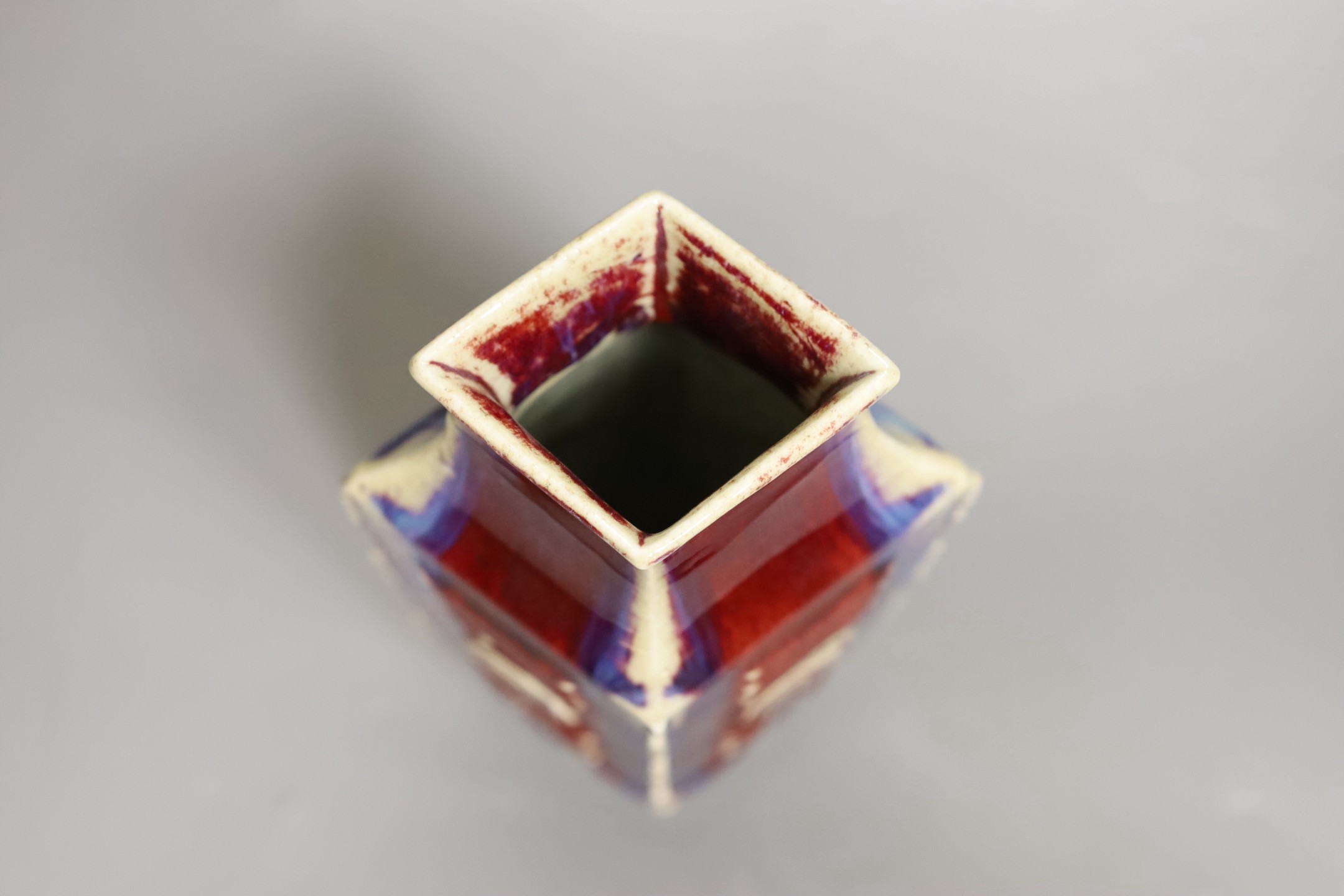 A Chinese flambe ‘eight trigrams’ lozenge section vase, late 19th / early 20th century, 22cm tall